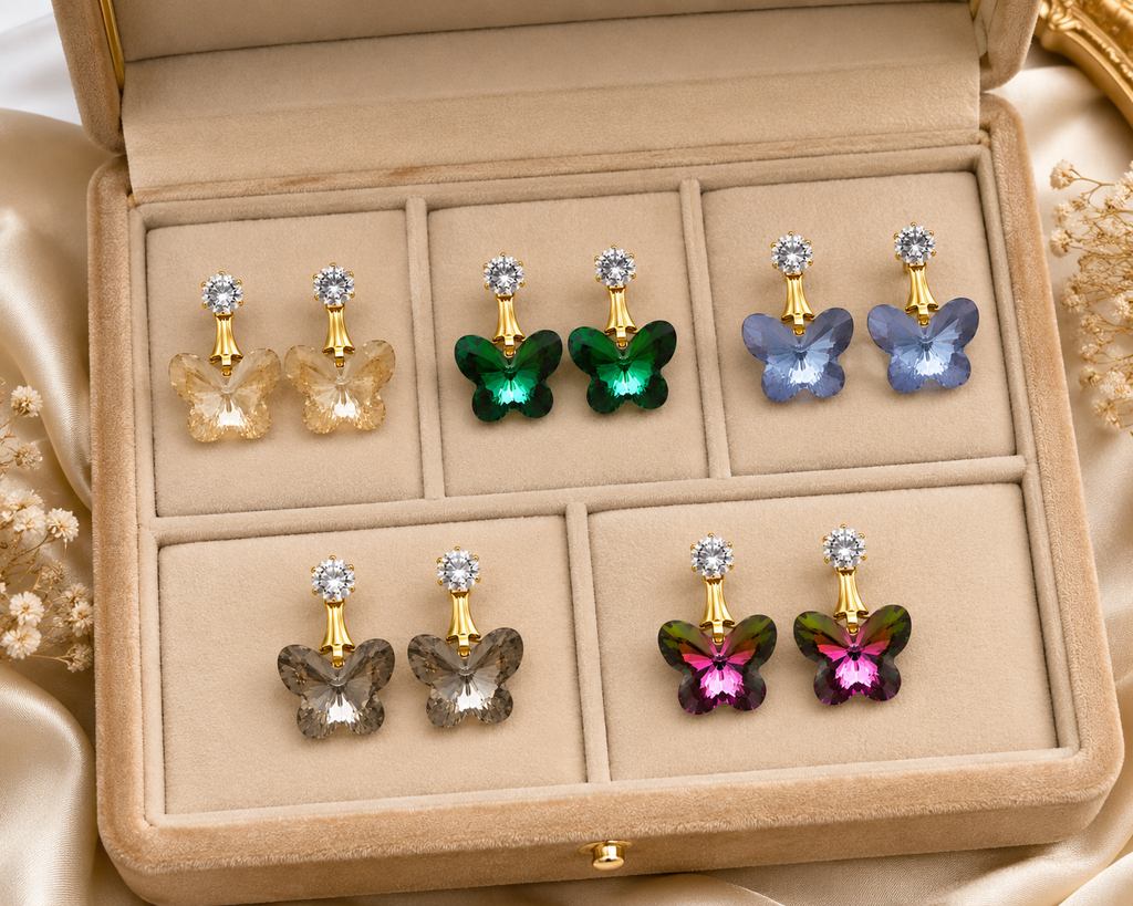 Gold-plated CZ stud and emerald green faceted butterfly crystal drop earrings product shot on white background showing full faceted wing detail and gold 6-prong crown CZ stud – AureliaBlends crystal butterfly earrings