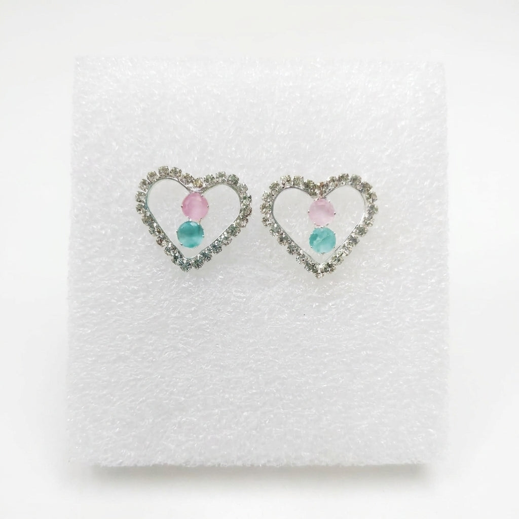 Silver pavé CZ open heart pink rose quartz and aquamarine blue stone stud earrings in an open dark walnut jewellery box with emerald green quilted velvet cushion on white marble – AureliaBlends