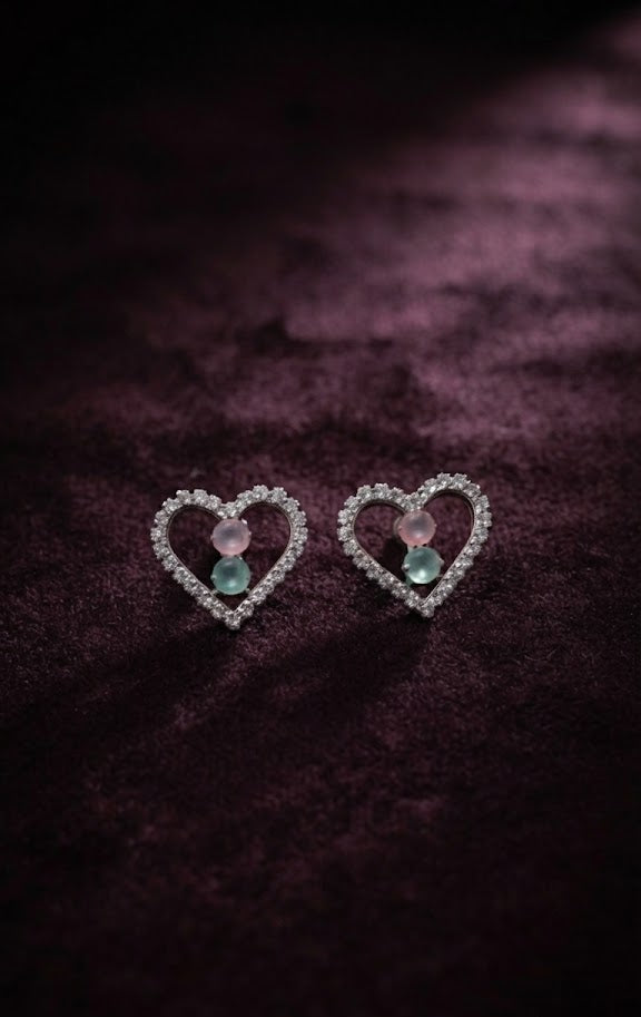 Silver pavé CZ open heart pink rose quartz and aquamarine blue stone stud earrings close-up on dark moody purple velvet showing pavé CZ heart frame and dual pastel stone centre detail – AureliaBlends