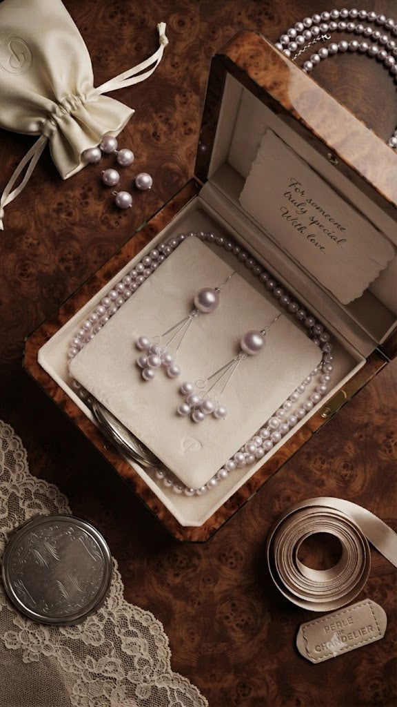 Silver lavender grey pearl cluster chandelier drop earrings close-up on dark background showing large pearl solitaire top, three silver bar arms and cascading pearl cluster drops – AureliaBlends chandelier earrings detail shot