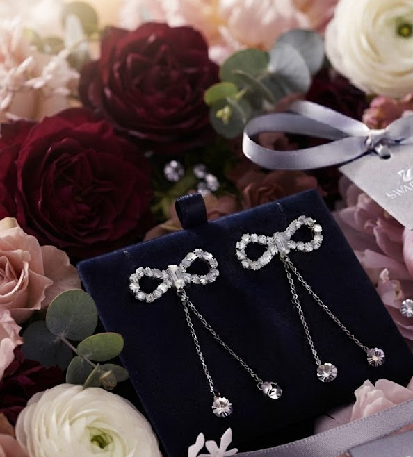Silver CZ open bow tassel chain drop earrings in an open navy blue velvet gift box with silver satin ribbon surrounded by blush and burgundy roses, ranunculus and eucalyptus – AureliaBlends bridal gift jewellery