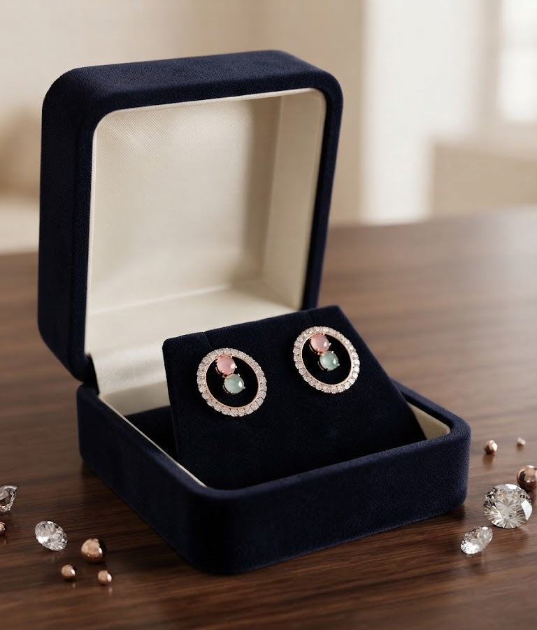 Rose gold pavé CZ open circle halo pink and mint stone stud earrings flat lay on champagne ivory rose petals and cream garden roses with scattered CZ stones and rose gold beads – AureliaBlends romantic floral editorial