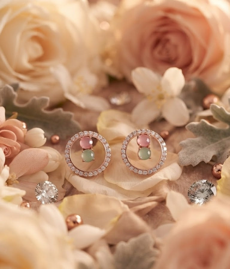 Rose gold pavé CZ open circle halo pink and mint stone stud earrings close-up on champagne floral background with cream roses and hydrangea showing halo frame and dual pastel stone centre detail – AureliaBlends pastel bridal earrings