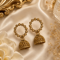 Gold jhumka earrings displayed in fine jewellery store – Luxeora timeless elegance AureliaBlends
