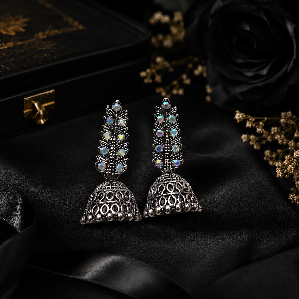 Model wearing oxidised silver AB crystal jhumka earrings with black saree – bridal jewellery AureliaBlends