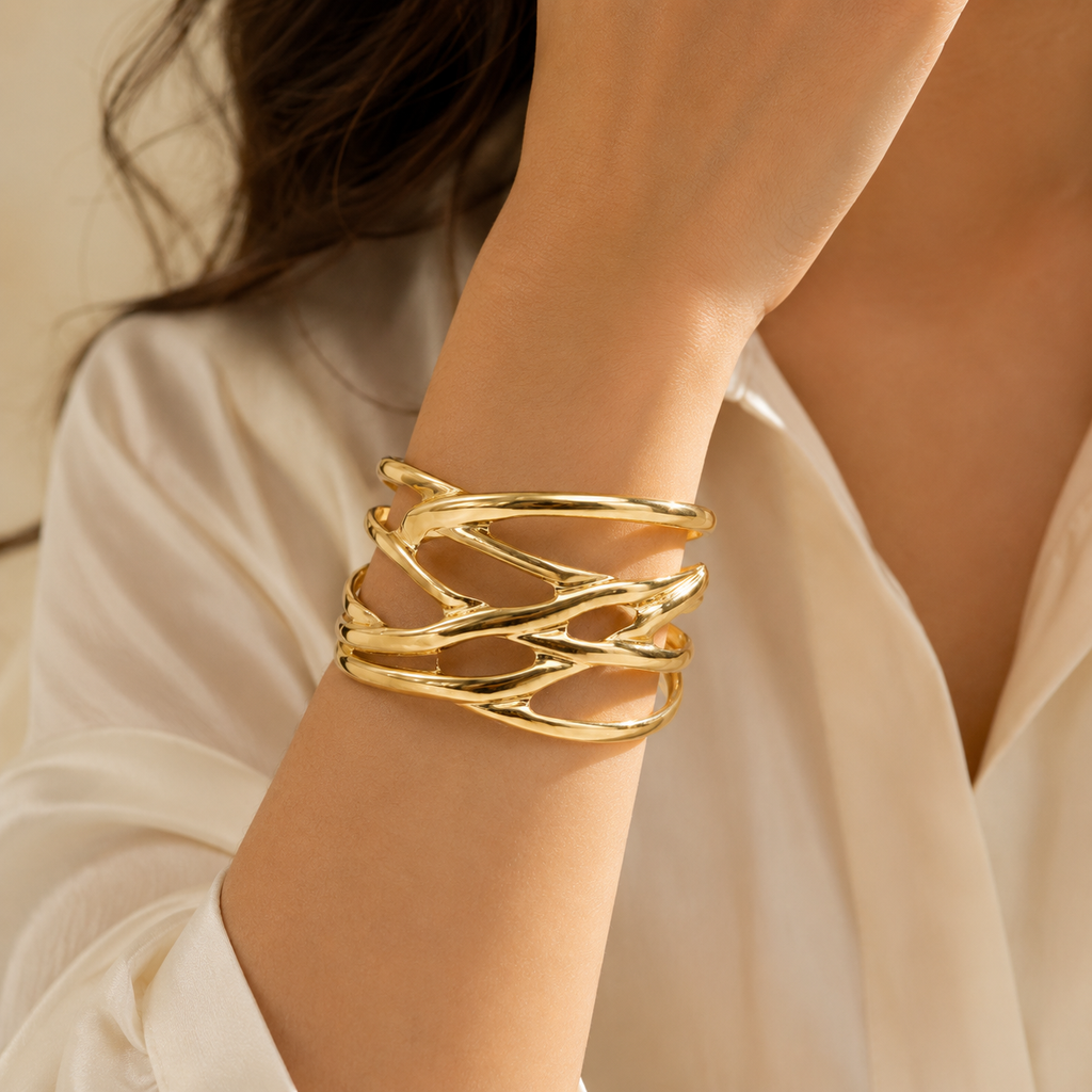 Woman wearing gold open weave cuff bracelet on wrist in white shirt – AureliaBlends statement gold bangle