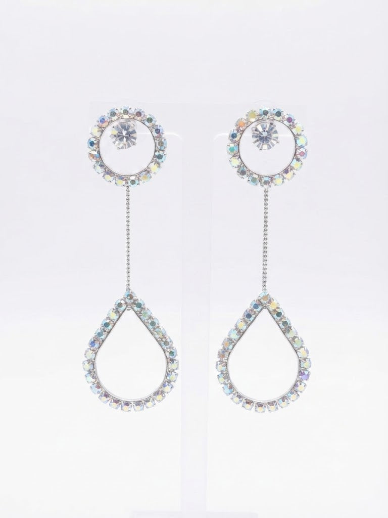 Model wearing silver CZ round halo solitaire chain teardrop pavé long drop earrings with a sleek low bun in a warm champagne neutral interior – AureliaBlends bridal statement dangle earrings side profile close-up