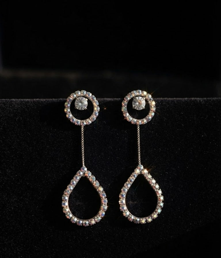 Silver CZ round halo solitaire chain teardrop pavé long drop earrings close-up on dark black velvet showing full pavé CZ open halo stud, delicate silver box chain and open pavé CZ teardrop frame – AureliaBlends long drop earrings detail shot
