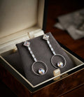 Silver CZ crystal hoop drop earrings on black background – AureliaBlends statement dangle earrings