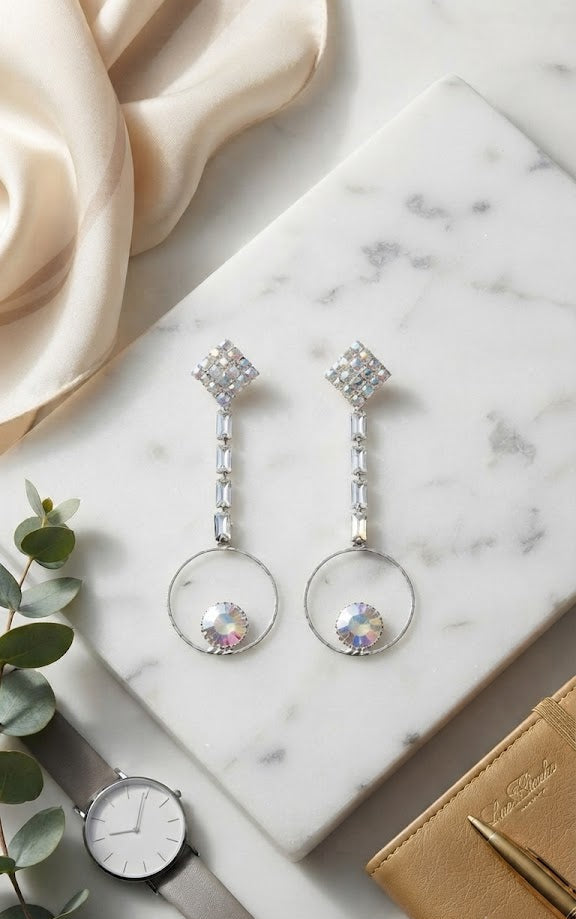 Aurora crystal hoop drop earrings on dark velvet with Dior books and gloves – AureliaBlends editorial