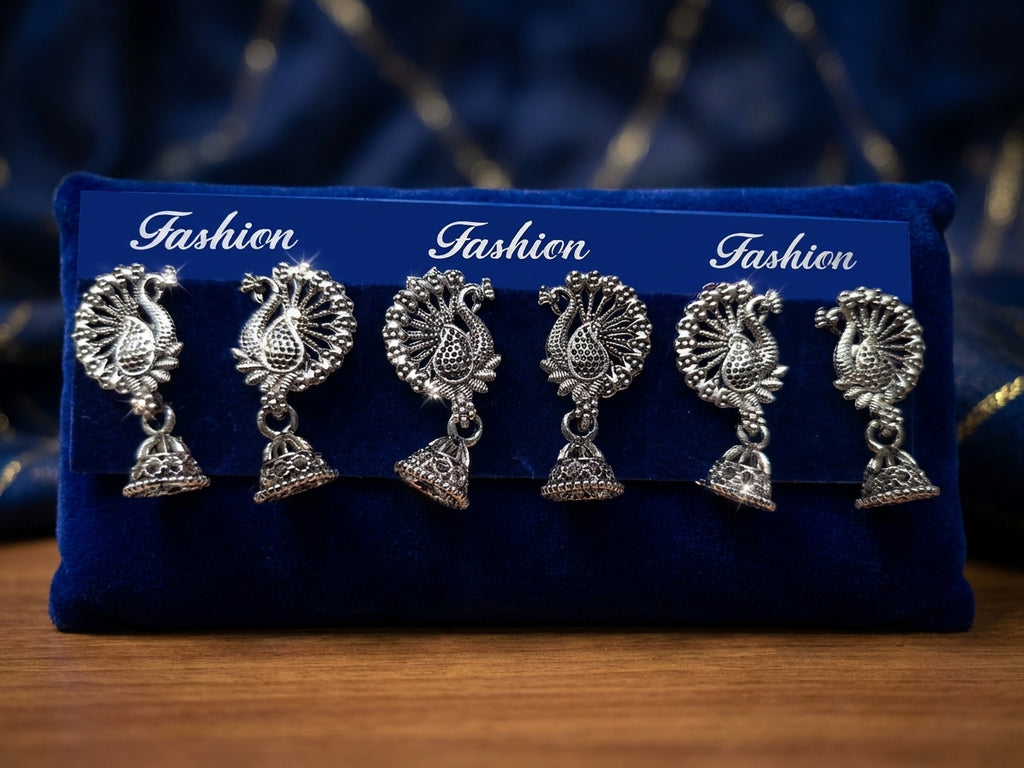Oxidized silver peacock jhumka earrings styled on navy blue velvet with accessories, sunglasses and oud perfume – AureliaBlends lifestyle shot