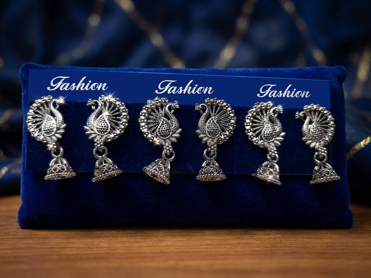 Oxidized silver peacock jhumka earrings styled on navy blue velvet with accessories, sunglasses and oud perfume – AureliaBlends lifestyle shot