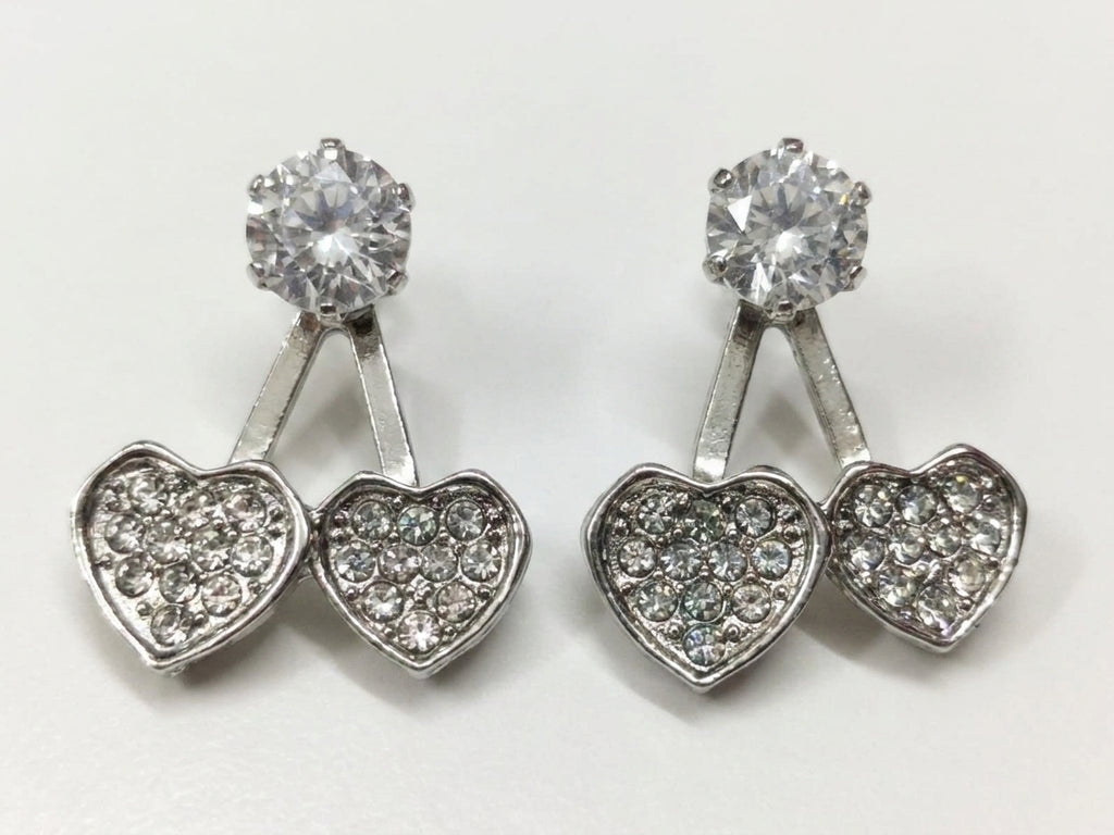 Model wearing silver CZ double heart ear jacket earrings with a sleek updo – side profile close-up – AureliaBlends Diamond Heart Collection
