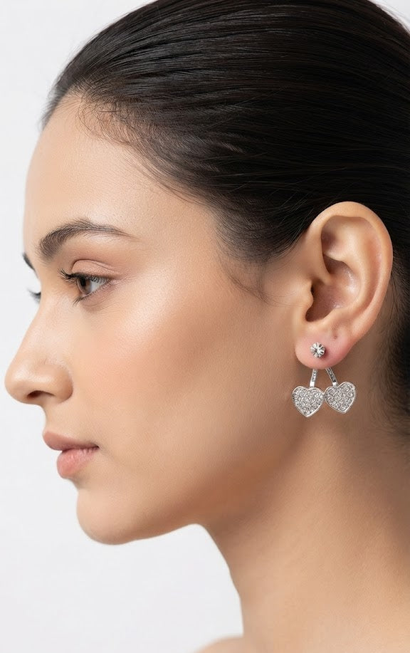 Silver CZ double heart ear jacket earrings flat lay on black marble with loose CZ stones, cream leather jewellery case, gold pen and Diamond Heart Collection tag – AureliaBlends