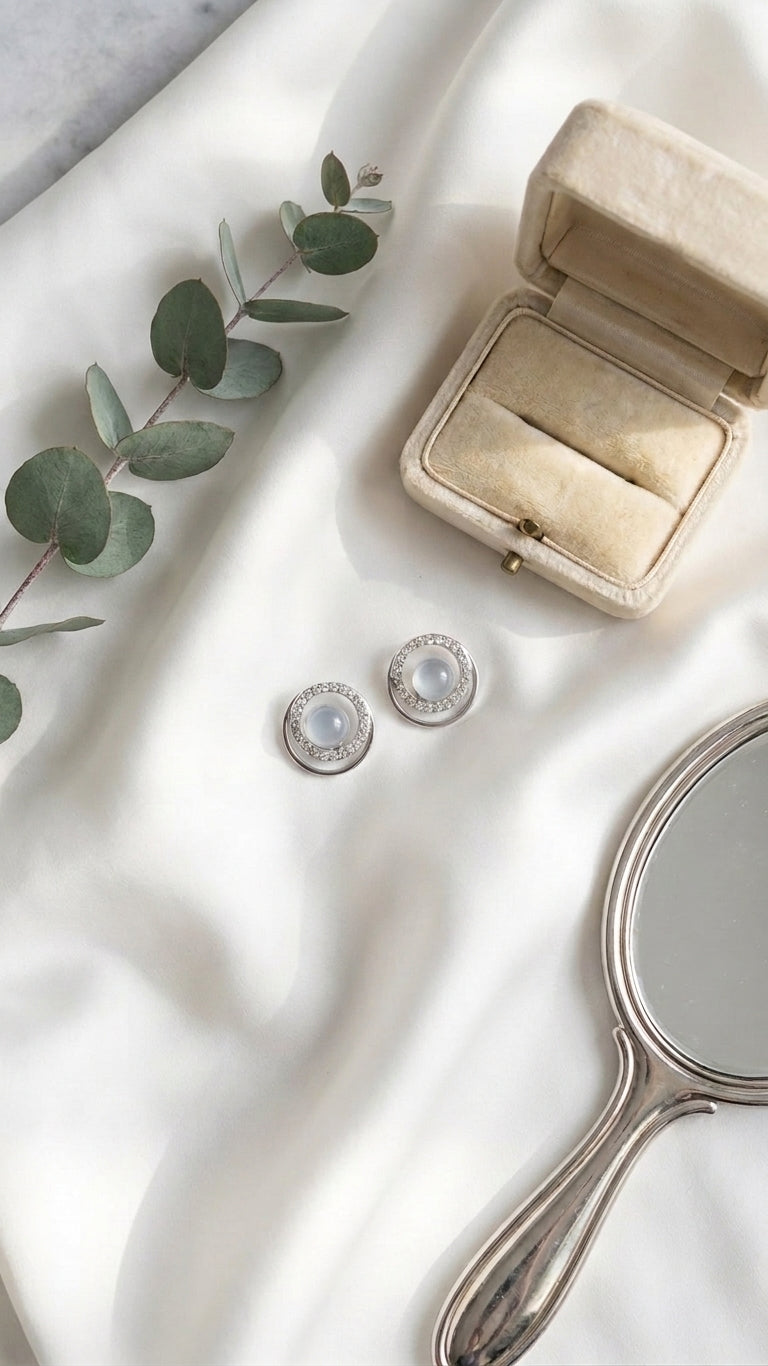 Silver double halo CZ grey pearl stud earrings flat lay on black velvet with loose pearls, CZ stones, eucalyptus sprig, vintage hand mirror and open cream velvet jewellery box – AureliaBlends dark editorial